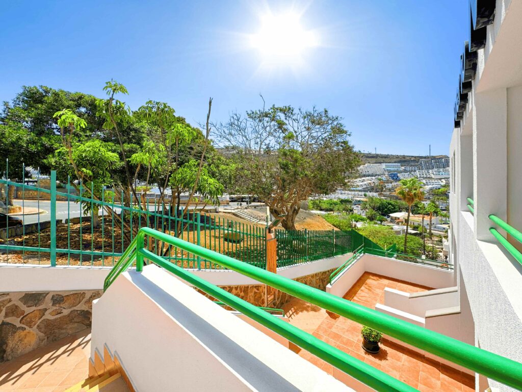 02 Puerto Mar Apartments in Puerto Rico Garden Pathway with Green Railings and Lush Tropical Landscaping in Quiet Area