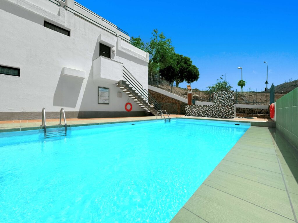 03 Puerto Mar Apartments in Canaria Swimming Pool Area with Sun Loungers and Clean Blue Water Ideal for Family Holidays